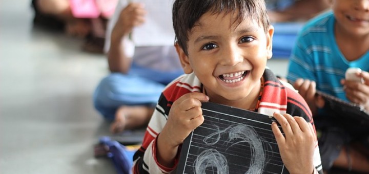 A boy having smiling in a classroom
